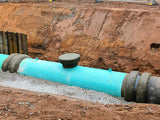 Buried pipe joint wrapped in Denso Tape before backfilling